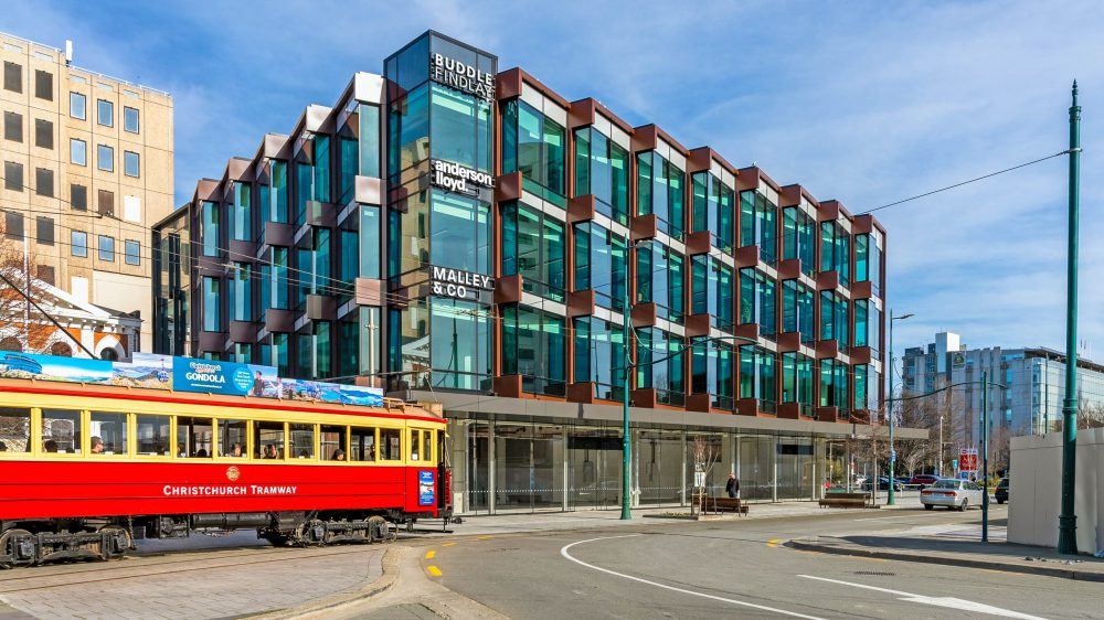 The Anderson Lloyd building on Oxford Terrace, Christchurch, with a heritage tram passing