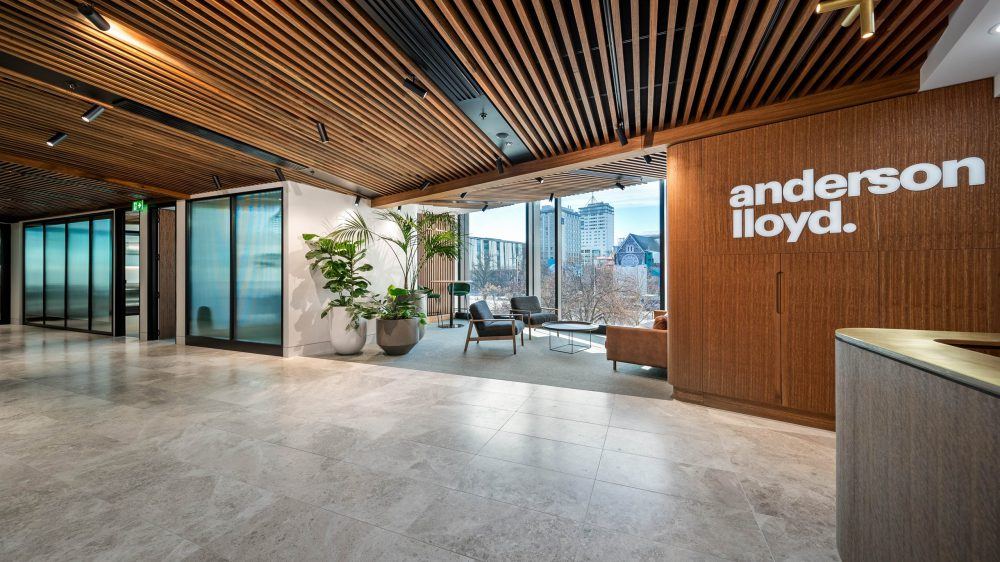 Reception lobby with branded timber wall, glazed office fronts and timber slat ceiling