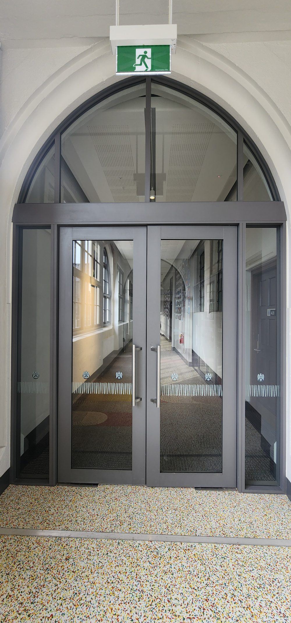 Bespoke aluminium partitions integrated into the heritage arched hallway at Christchurch Boys High School