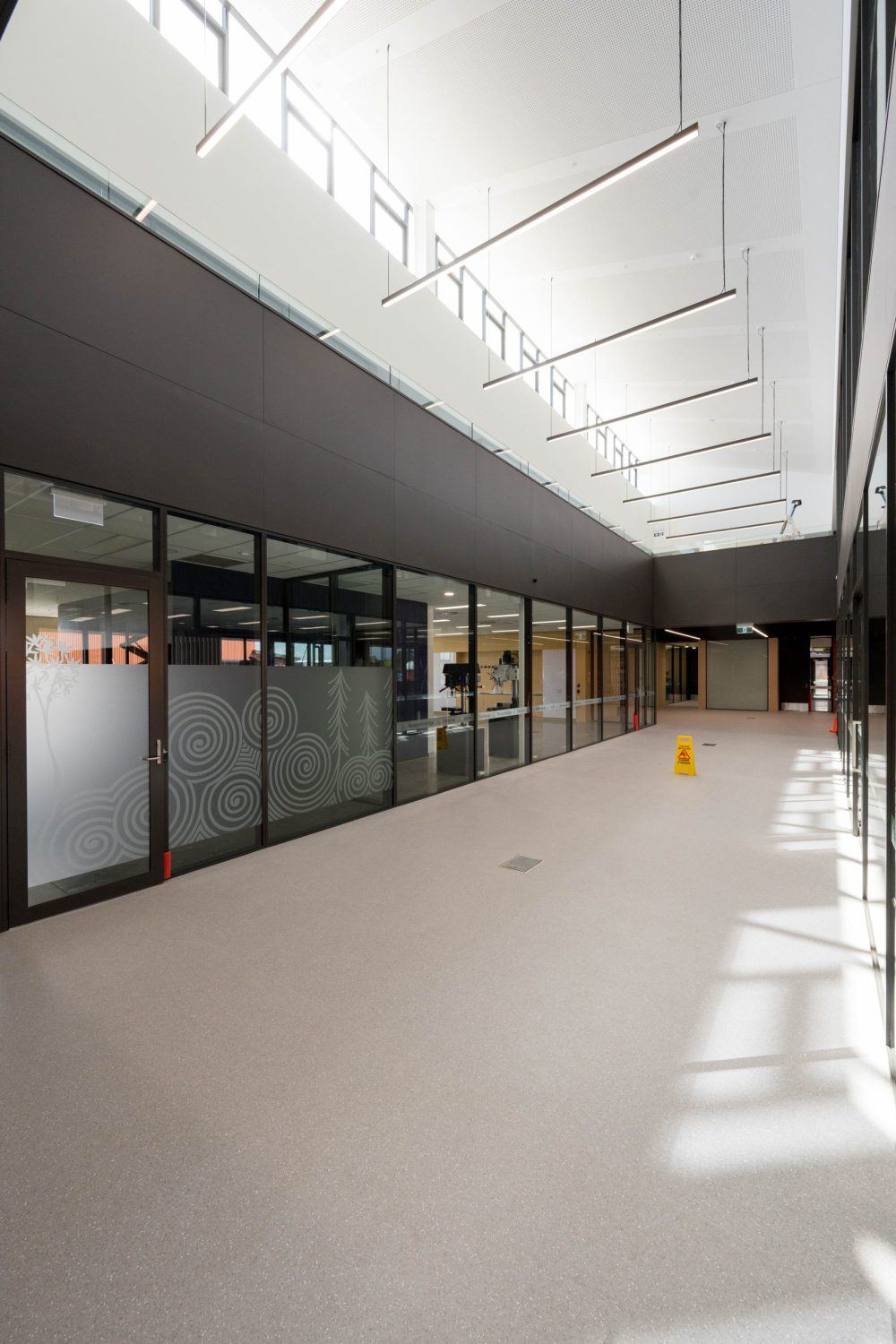 Glazed partitions lining the technology and engineering workshops at Rolleston College